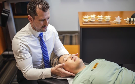 Chiropractor St Paul MN Jeremy Hurkman Adjusting Patient Neck