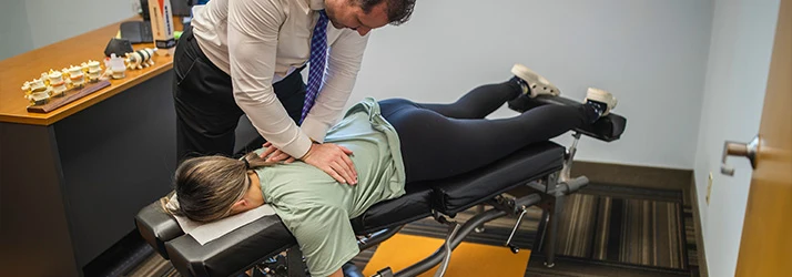 Chiropractor St Paul MN Jeremy Hurkman Adjusting Patient With Back Pain