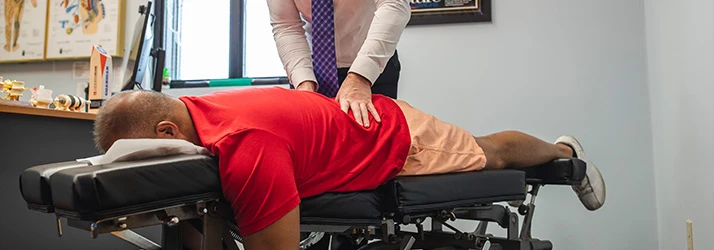 Chiropractor St Paul MN Jeremy Hurkman Adjusting Patient With Low Back Pain