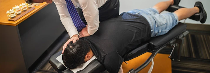 Chiropractor St Paul MN Jeremy Hurkman Adjusting Patient With Shoulder Pain